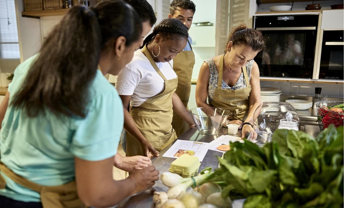 des collègues participent à une activité Team Building cuisine en Écolodge pendant un séminaire au vert