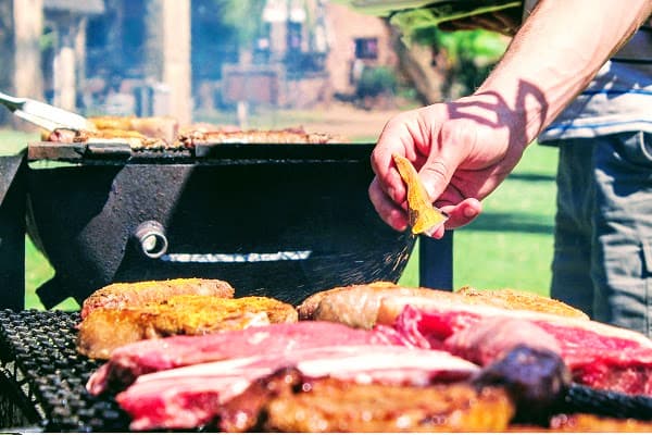 une personne s'occupe d'un barbecue.